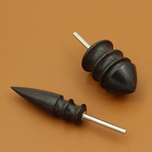 Leather edge burnishing heads with pointed and rounded black tips and metal shafts