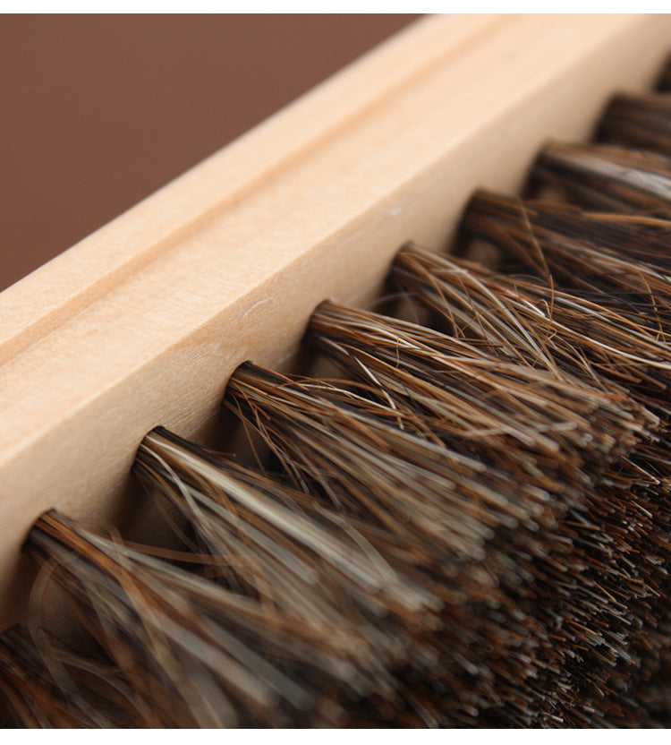 Horsehair brush with wooden handle, dense dark and brown bristles in wooden holder