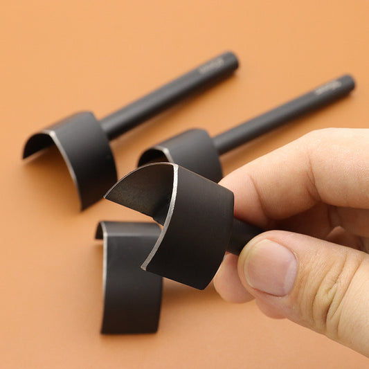Black belt strap tail cutter head, V-shaped notch held near a hand