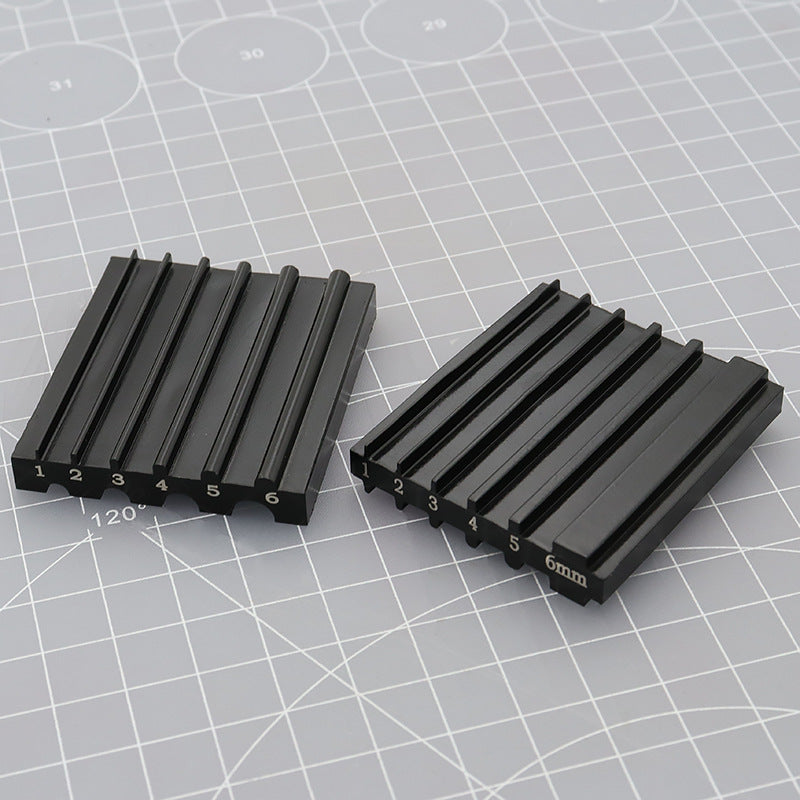 Pair of black beveler & skiving knife sharpener tools with numbered slots and 6mm guide