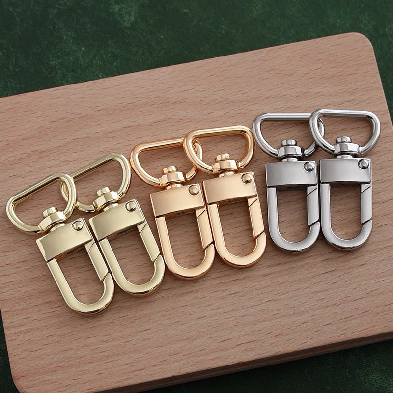 Mixed set of swivel snap hooks in silver and gold tones for bag hardware.
