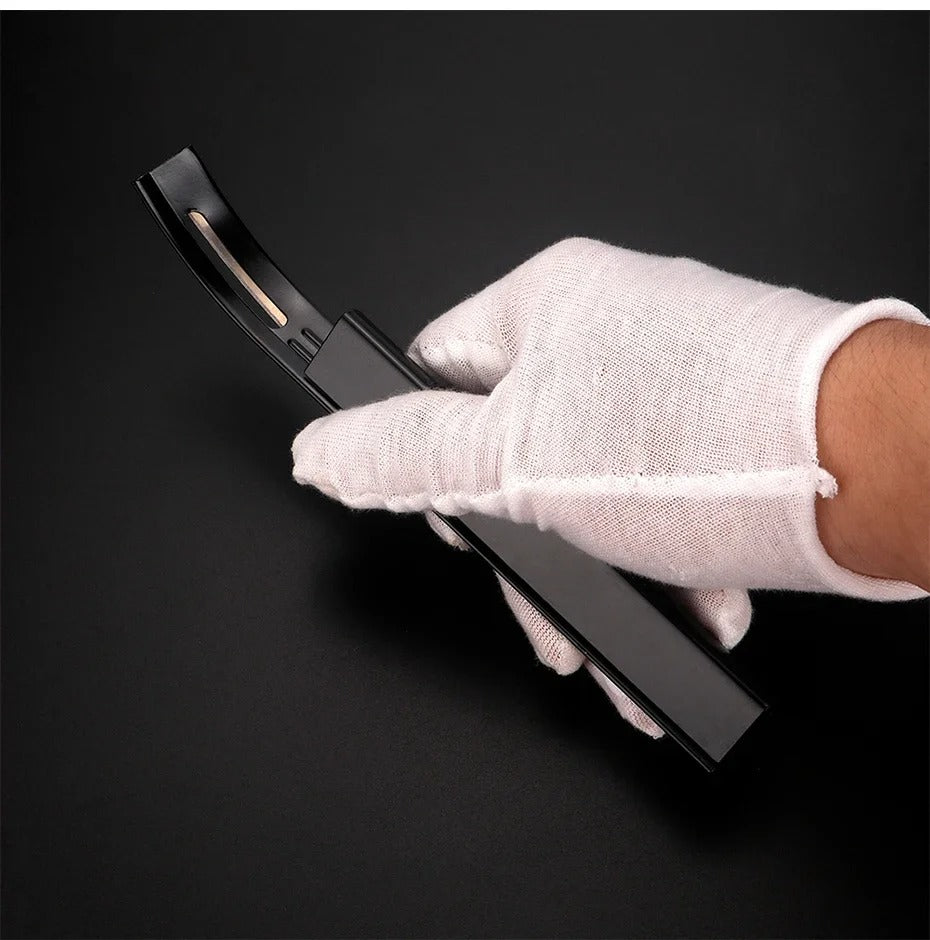 Black leather safety beveler with three-blade insert, handled with a glove