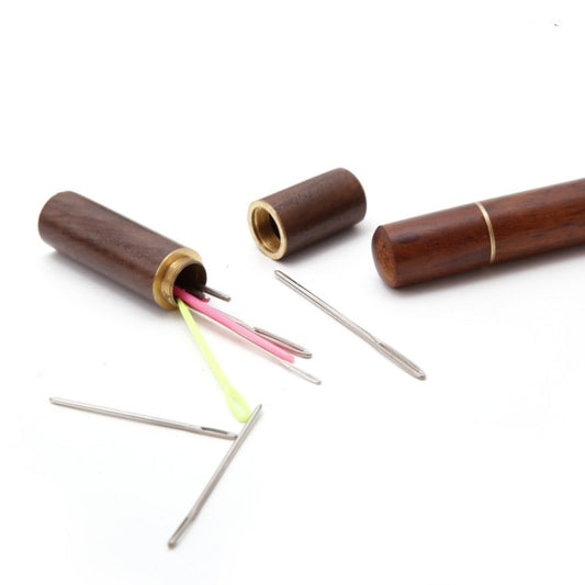 Cylindrical needle storage case with brass ends and needle slots