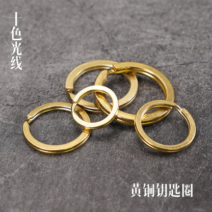 Solid brass key ring set with four interlinked round loops, polished gold finish