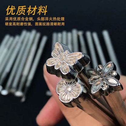 Close-up of silver plated embossing stamp heads with butterfly and flower motifs