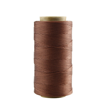 Brown waxed polyester stitching thread spool with visible thread texture