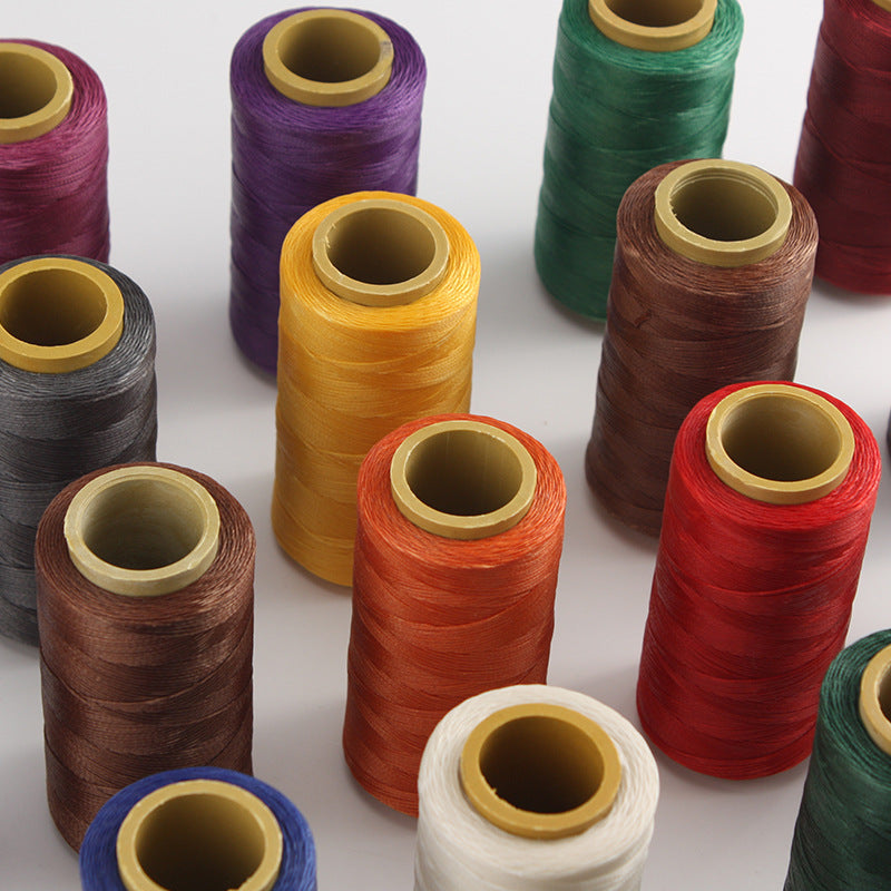 Set of waxed polyester stitching thread spools in assorted colors