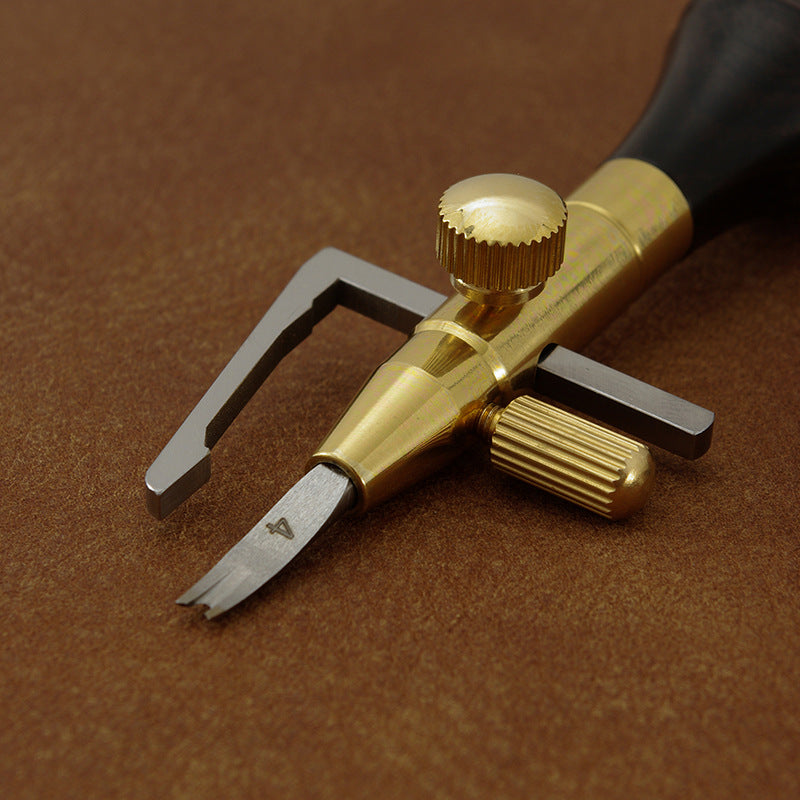 Leather edge cutter head close-up with brass adjuster and small cutting blade