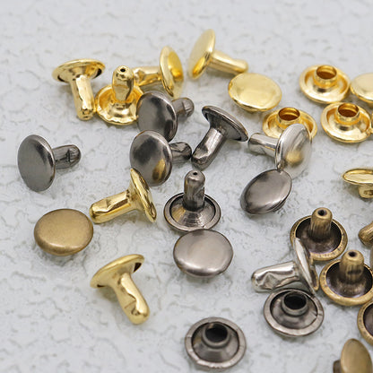 Close-up of double-cap leather rivets in brass, black, and silver tones