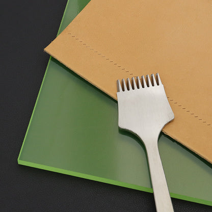 Green punching pad board with layered edge and a chisel resting on top