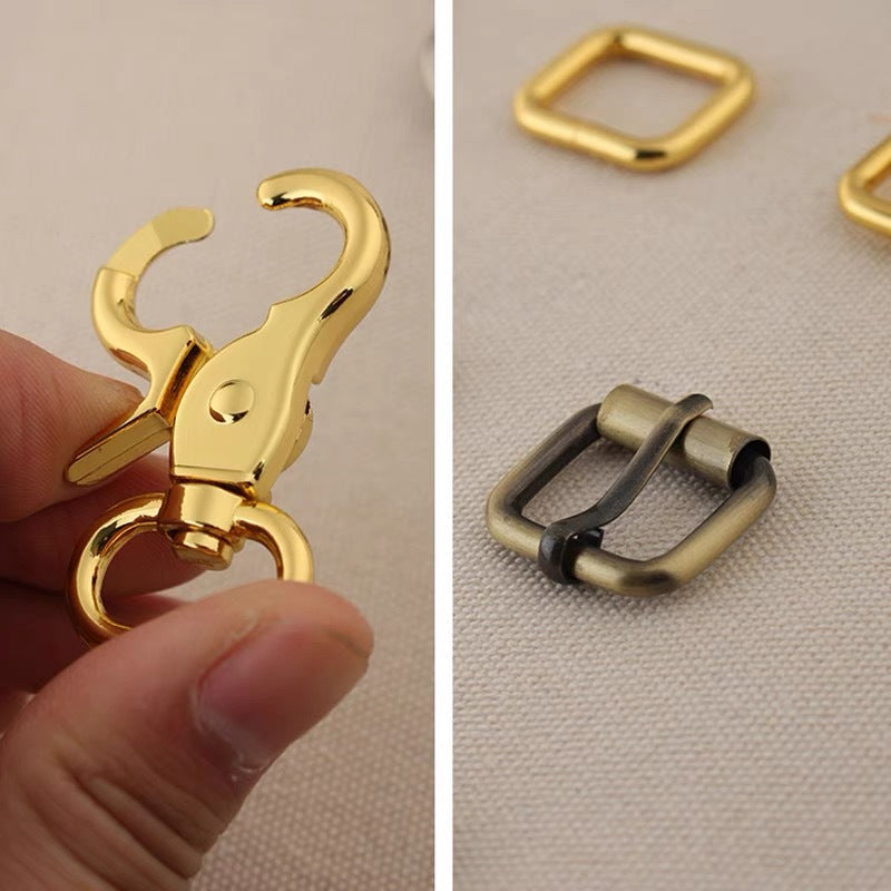 Bag hardware set close-up: gold swivel clasp with matching rings and strap adjuster