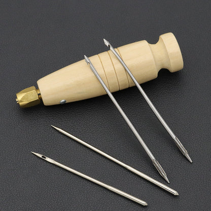 Wooden handle sewing awl set with brass head and four metal needle tips laid out
