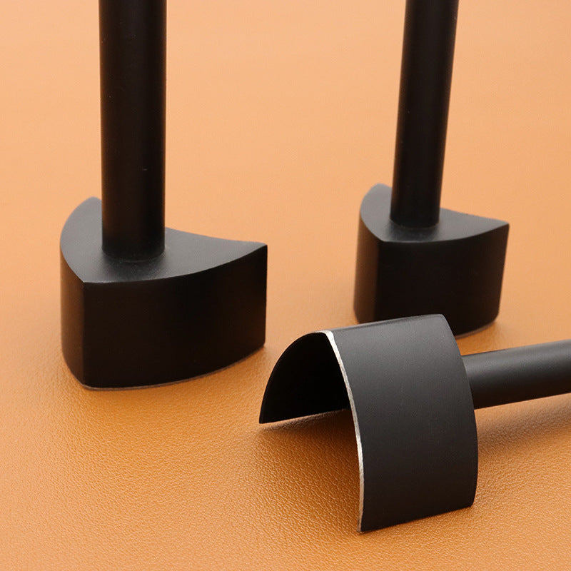 Black V-shaped punch cutters with raised handles on work surface