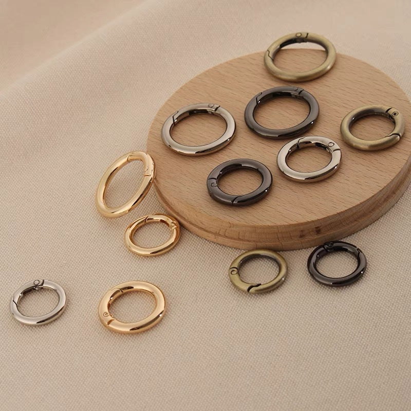 Zinc alloy spring open split rings in gold, silver, and dark tones
