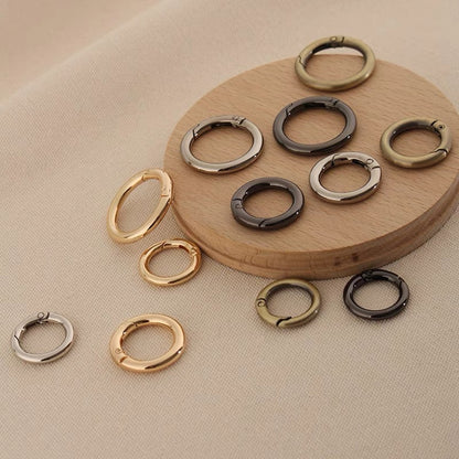 Zinc alloy spring open split rings in gold, silver, and dark tones