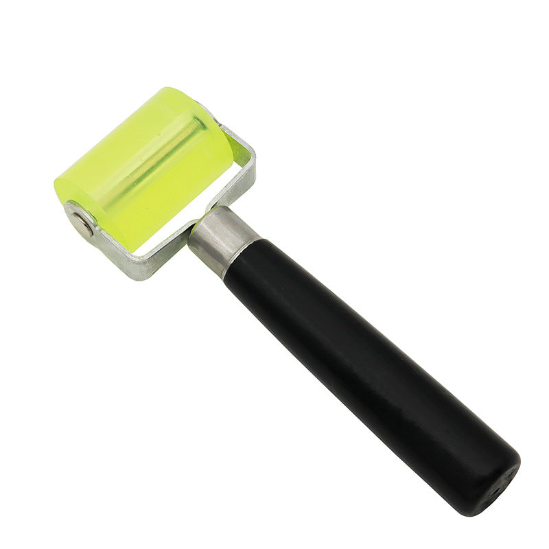 Silicone glue application roller tool with lime green silicone wheel and black handle