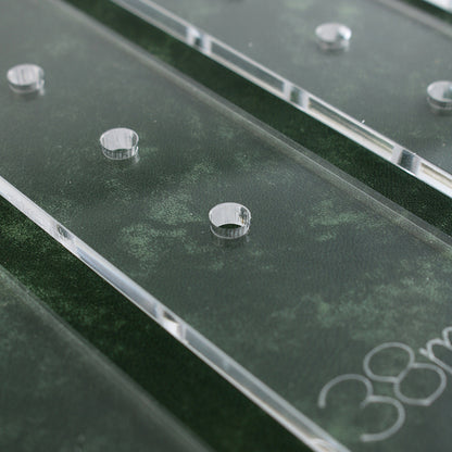 Clear acrylic strip with punched hole guide marks along the length