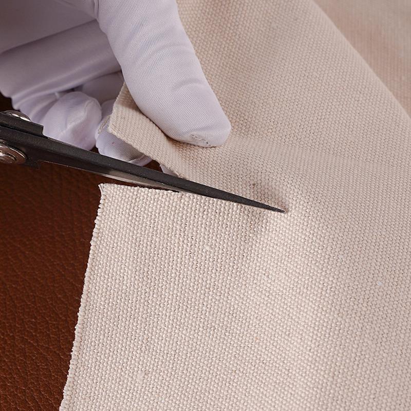 Off-white polishing cloth buffing a leather edge under a white glove