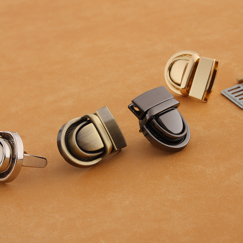 Metal twist-lock bag buckles with gunmetal, antique gold, and dark finish accents