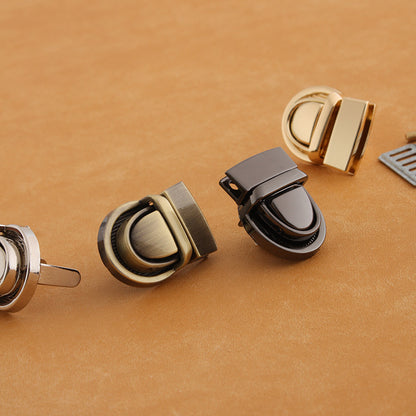 Metal twist-lock bag buckles with gunmetal, antique gold, and dark finish accents