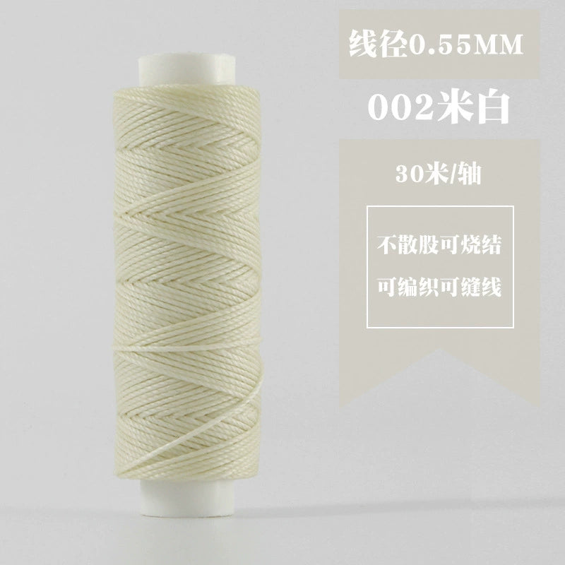 Off-white waxed round thread spool, tightly coiled on white plastic reel