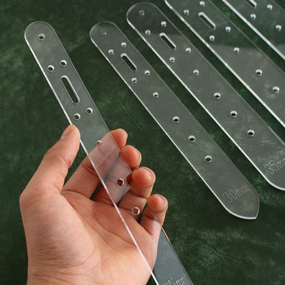 Set of clear acrylic belt hole templates with multiple rows of punched holes