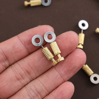 Brass leather positioning needles held in hand with round metal washers and brass ends