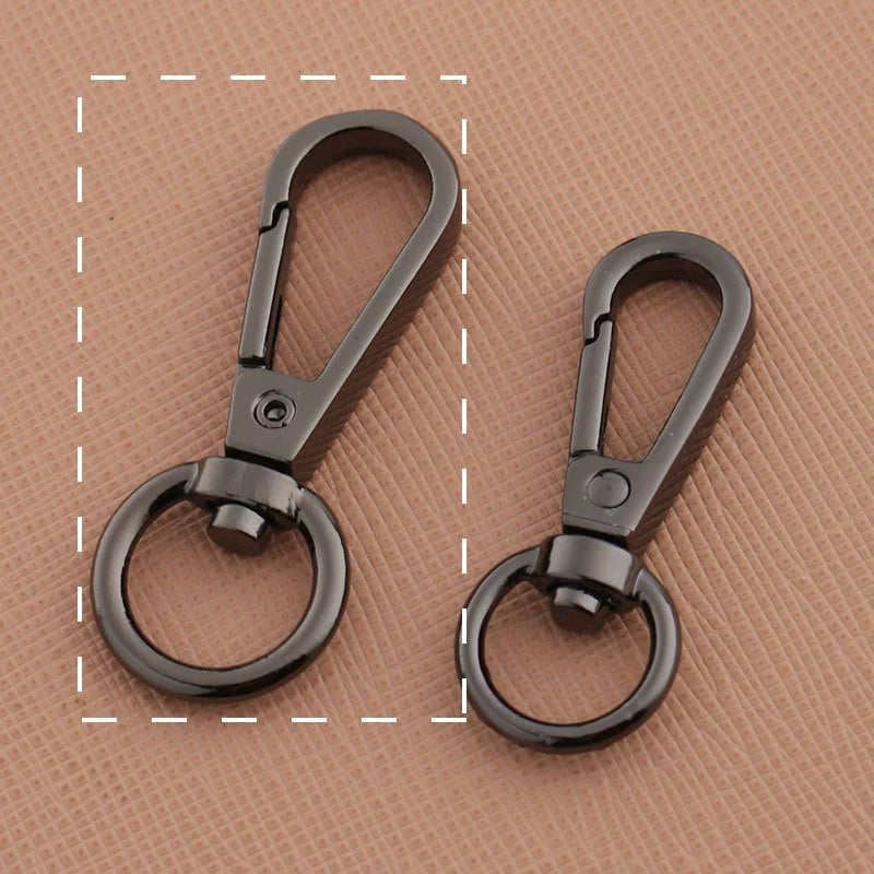 Swivel lobster claw hook buckles in gunmetal-tone metal, showing small and large rings