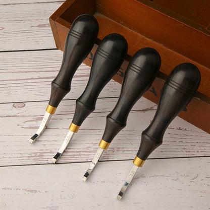 Leather creasing tools with dark handles, gold ferrules, and curved steel blades
