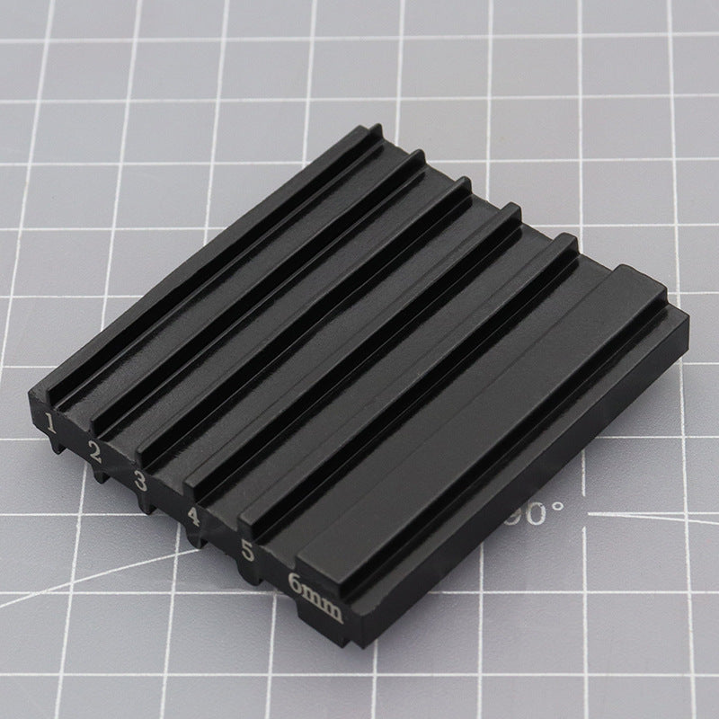 Black beveler & skiving knife sharpener tool with raised ridges and 6mm markings