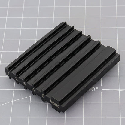 Black beveler & skiving knife sharpener tool with raised ridges and 6mm markings