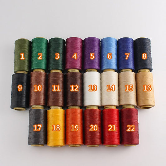 Assorted waxed polyester stitching thread spools with numbered colors