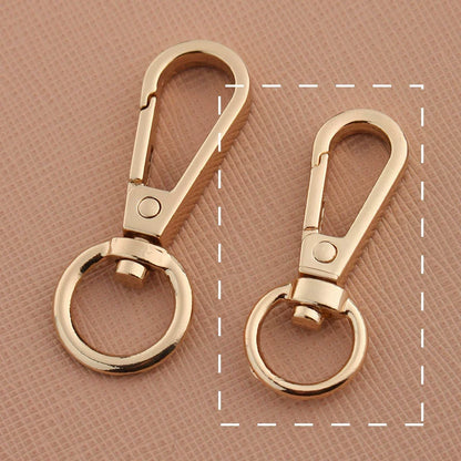 Swivel lobster claw hook buckle in gold-tone metal with round ring clasp
