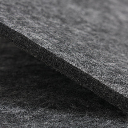 Dark grey felt mat close-up, dense fibrous surface texture