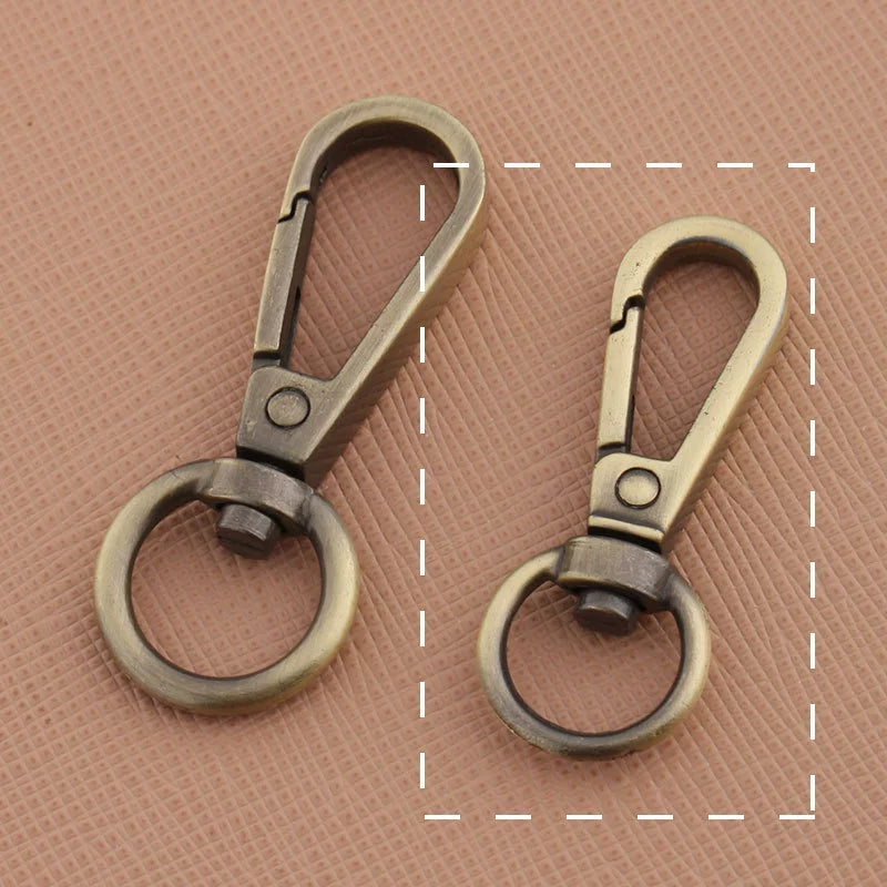 Swivel lobster claw hook buckle in antique dark and light metal tones with rings