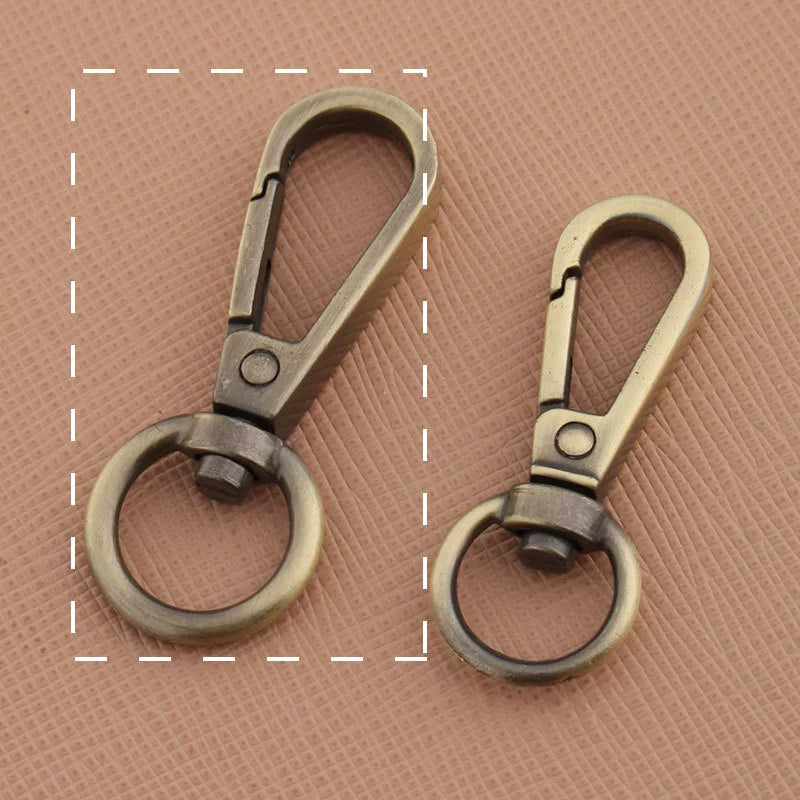 Swivel lobster claw hook buckles in dark and light antique tones, small and large rings