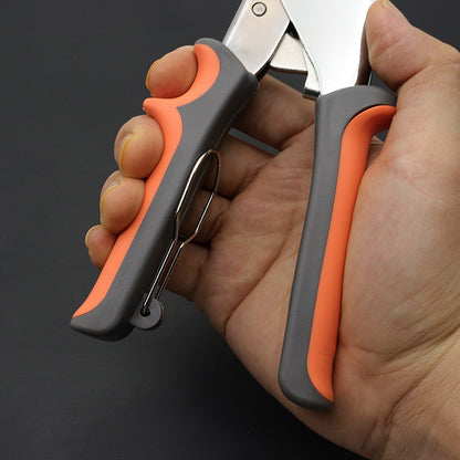 Eyelet setting pliers with orange-gray handles in hand, ready to punch grommets