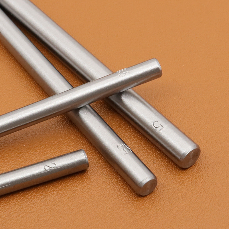 Metal round hole punch tools with marked barrel sizes, close-up