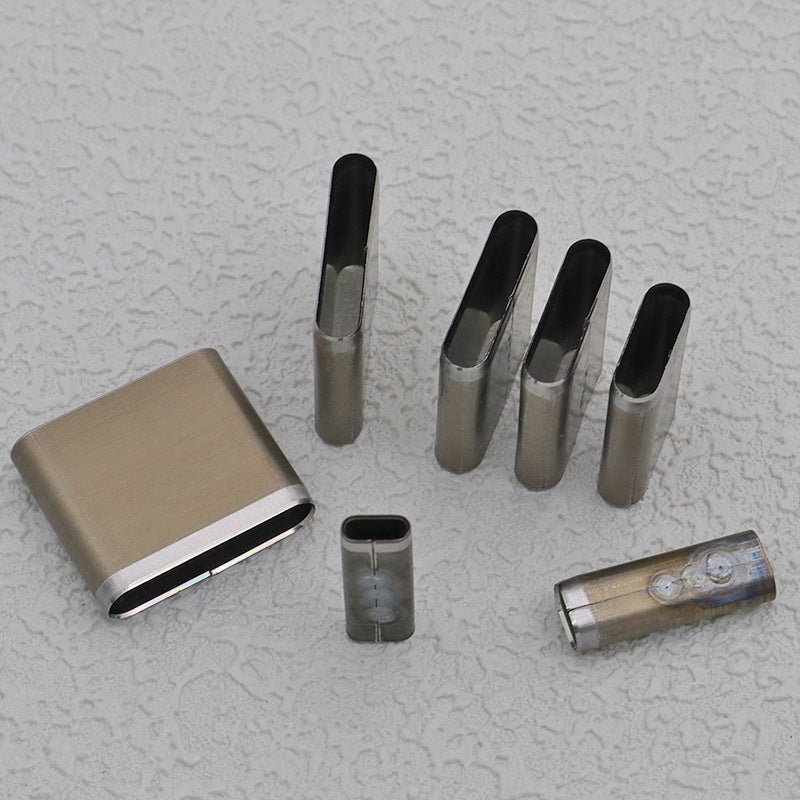 Slot punch die set arranged with steel oblong cutters and small cylindrical pieces