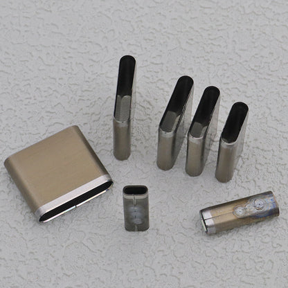 Slot punch die set arranged with steel oblong cutters and small cylindrical pieces