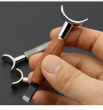 Swivel carving knife held in hand with rosewood handle and curved chrome yoke