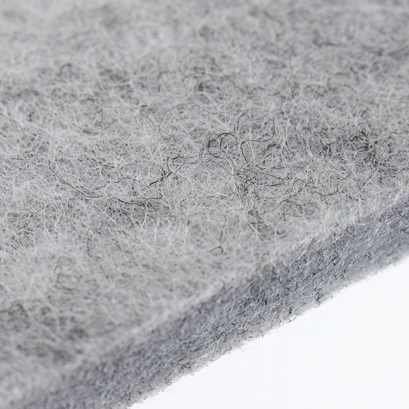 Light grey felt mat close-up, dense fibrous surface texture