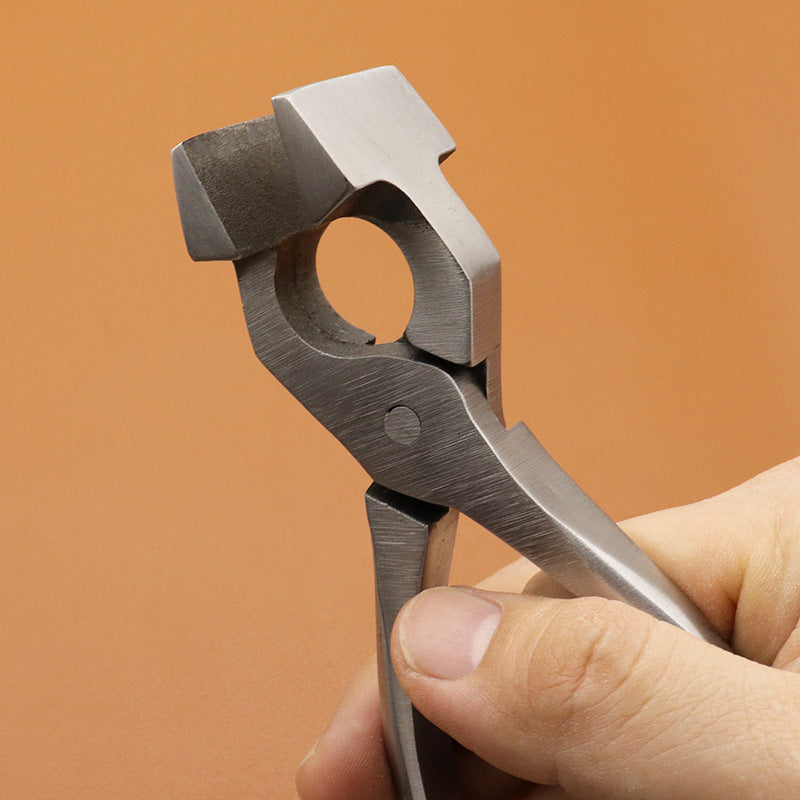Stainless chrome steel leather craft pliers, close-up of circular die jaw