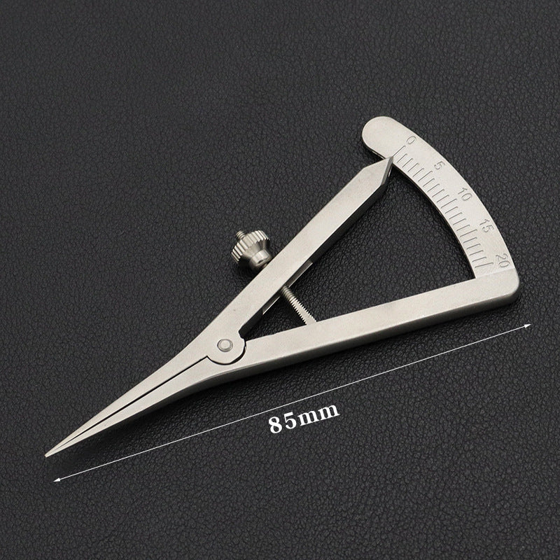 Adjustable wing divider with 85 mm range marking and mm scale on dark surface