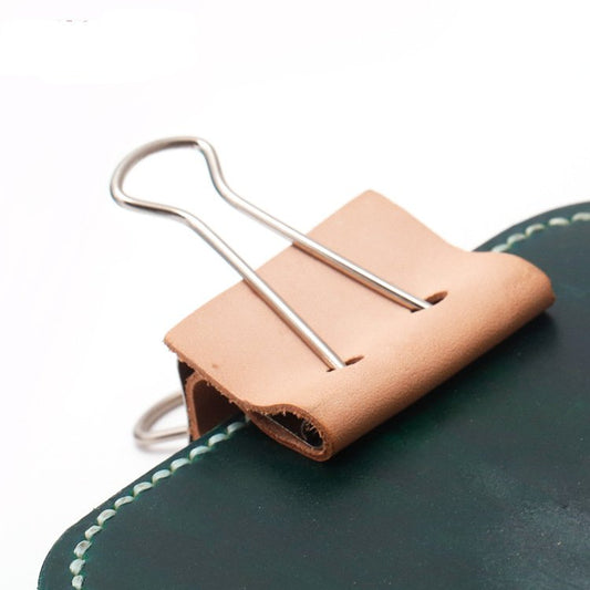 Vegetable tanned leather binder clip, close view of two metal prongs in sleeve