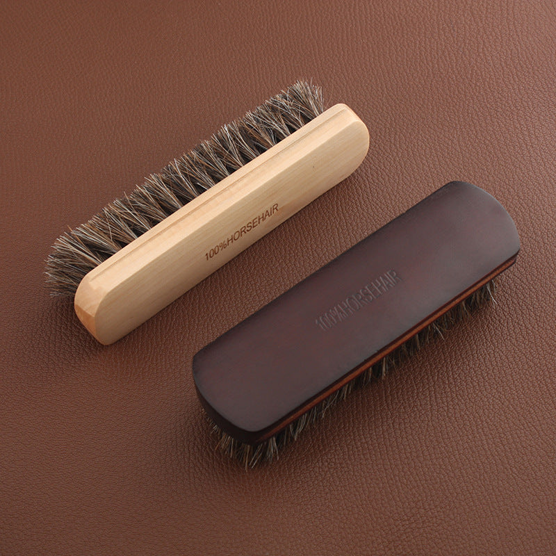 Horsehair brush with light wooden handle and dark cover, brown bristles