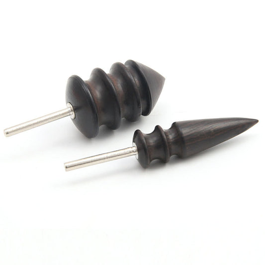 Two dark wooden earrings with metallic posts on a white background