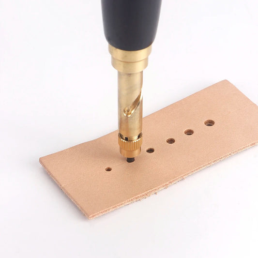 Leather rotary punch tool drilling holes in light brown leather sheet with metal tip